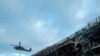 Sailors prepare to board the amphibious assault ship USS Bonhomme Richard to fight an ongoing fire at Naval Base in San Diego, Calif. on July 14, 2020. 