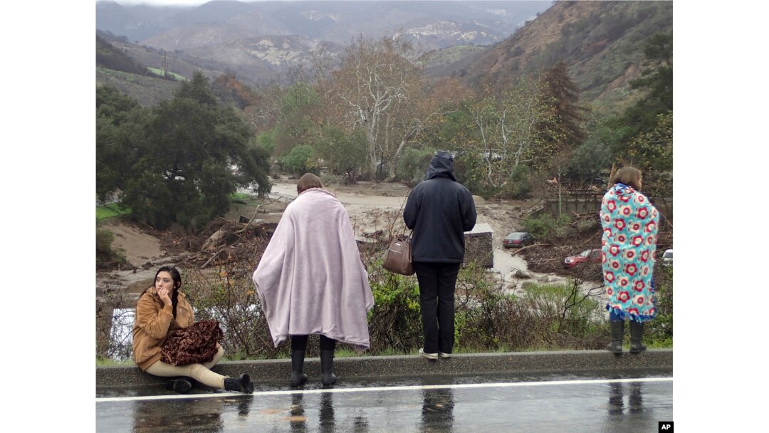 Rescued campers survey the scene at the El Capitan Canyon campground following flooding due to heavy rains, in Gaviota, Calif., Jan. 20, 2017.
