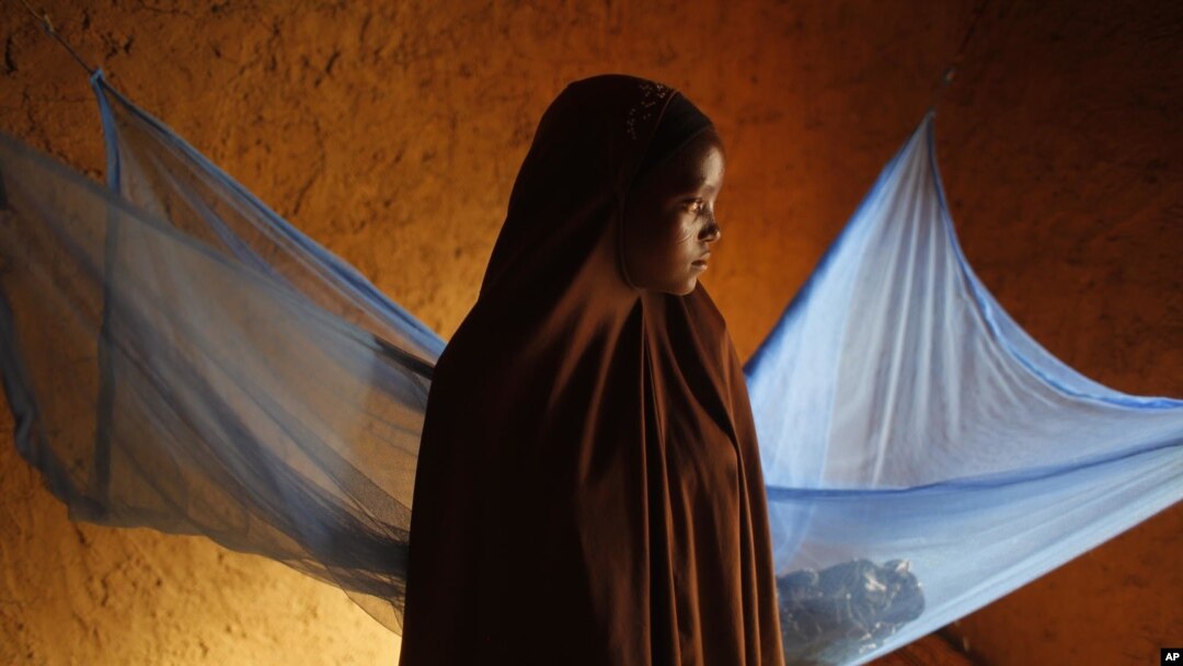 FILE - Zali Idy, 12, poses in her bedroom in the remote village of Hawkantaki, Niger, July 18, 2012. Zali was married in 2011. 