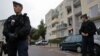 French gendarmes secure a garage entrance, where an anti-terrorist raid was conducted four days ago, in Torcy near Paris, October 10, 2012.