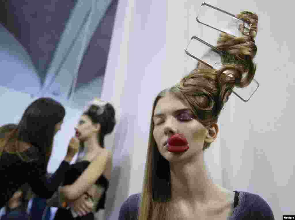 A model waits backstage during Ukrainian Fashion Week in Kyiv, Feb. 7, 2017.