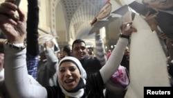 A supporter of deposed Egyptian president Hosni Mubarak celebrates and shouts slogans outside a High Court in Cairo, January 13, 2013. 