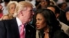FILE - Republican presidential nominee Donald Trump and Omarosa Manigault attend a church service in Detroit, Michigan, Sept. 3 2016. 