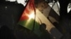 An Egyptian woman waves the Palestinian flag in solidarity with Gaza during a protest against Israel's military operation in the region, in Cairo, Egypt, November 15, 2012.