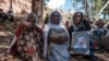 FILE - People mourn the victims of a massacre allegedly perpetrated by Eritrean soldiers, in the village of Dengolat, north of Mekele, the capital of Ethiopia's Tigray region, Feb. 26, 2021.