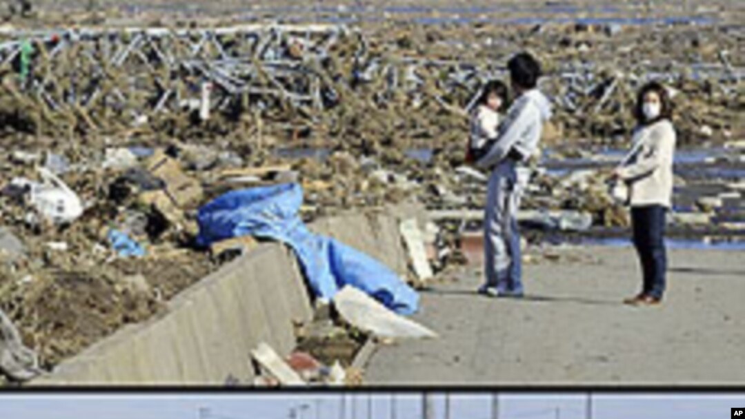 This combination of pictures shows local residents looking at a tsunami-hit area of Minamisoma, Fukushima Prefecture on March 12, 2011 (top) and the same area on January 11, 2012 (bottom). 