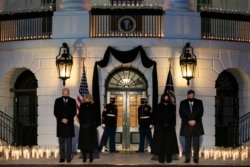 President Joe Biden, first lady Jill Biden, Vice President Kamala Harris, and Doug Emhoff participate in a moment of silence during a ceremony to honor the 500,000 Americans that died from COVID-19, at the White House, Feb. 22, 2021.