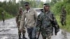 Congolese M23 rebel soldiers are seen on the road to Rushuru near Buhumba some 25 kilometers (16 miles) north of Goma, November 22, 2012.