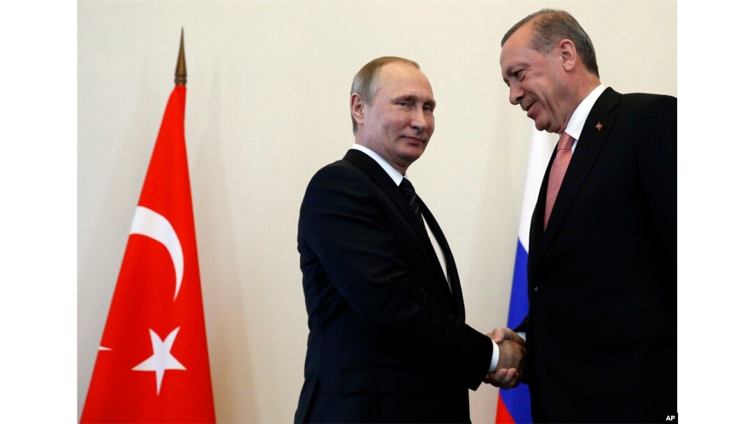 Russian President Vladimir Putin, left, welcomes Turkish President Recep Tayyip Erdogan in the Konstantin palace outside St.Petersburg, Russia, on Aug. 9, 2016.