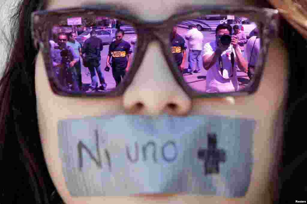 Journalists are reflected on sunglasses of a woman during a protest against the murder of the Mexican journalist Miroslava Breach, outside the Attorney General's Office (PGR) in Ciudad Juarez, Mexico, March 25, 2017.