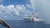 FILE - Chinese Coast Guard members approach Filipino fishermen as they confront each other off Scarborough Shoal in the South China Sea, also called the West Philippine Sea, Sept. 23, 2015.