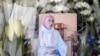 A picture of late Father Jacques Hamel is placed on flowers at the makeshift memorial in front of the city hall closed to the church where an hostage taking left a priest dead the day before in Saint-Etienne-du-Rouvray, Normandy, France, July 27, 2016. 