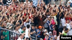 FILE - A crowd of migrants and refugees, mostly from Syria, are seen at the main bus station in Istanbul, Turkey, Sept. 17, 2015.