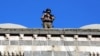 FILE - A special security member stands atop a historical building a day after seven police officers were killed in an explosion caused by a bomb-laden car, in the mainly Kurdish city of Diyarbakir, Turkey, April 1, 2016.