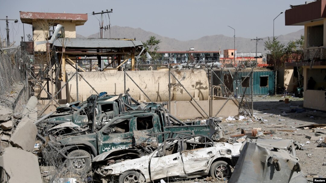 Damaged police vehicles are seen at the site of a blast in Kabul, Afghanistan, Aug. 7, 2019. 
