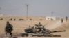 FILE - FILE - Turkish tanks and troops are deployed near the Syrian town of Manbij, Syria, Oct. 15, 2019.