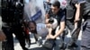 FILE - Riot police detain a demonstrator during a protest against the suspension of teachers from classrooms over alleged links with Kurdish militants, in the southeastern city of Diyarbakir, Turkey, Sept. 9, 2016. 