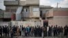 Iraqi civilians line up to receive food supplies in a neighborhood recently liberated by Iraqi security forces in western Mosul, March 14, 2017. 