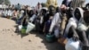 FILE - Internally displaced persons wait to be served with food at Dikwa camp, in northeast Nigeria's Borno state, Feb. 2, 2016. More than 5.1 million people are severely food insecure in parts of Borno, Adamawa and Yobe states in northeastern Nigeria.
