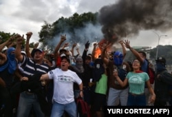 VENEZUELA -- Venezuelan opposition demonstrators, chant slogans during a protest against the government of President Nicolas Maduro, on the anniversary of 1958 uprising that overthrew military dictatorship in Caracas on January 23, 2019.