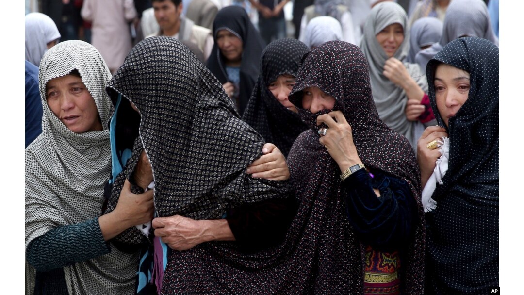 FILE - Afghan women mourn during the funeral of victims who died from a suicide attack, in Kabul, Afghanistan, July 24, 2016.