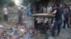 People inspect the damage at a market hit by airstrikes in Idlib city, Syria, June 5, 2016. 