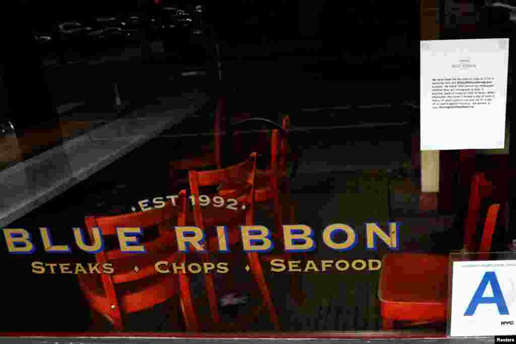 A sign posted for customers hangs on the window of Blue Ribbon restaurant, stating that they are closed in solidarity with "A Day Without Immigrants" protests in Brooklyn, New York.
