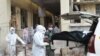 Medical staff in protective suits remove a dead body from a vehicle upon arriving at the Civil Hospital in Ahmedabad on Aug. 6, 2020, after a fire at Shrey Hospital killed eight coronavirus patients.