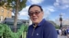 Australian writer Yang Hengjun wishes Happy New Year to his Twitter followers at an unidentified location in this still image from an undated video obtained via social media. (Twitter @YANGHENGJUN)