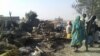 FILE - People return to the site after a bombing attack of an internally displaced persons camp in Rann, Nigeria Jan. 17, 2017.