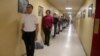 New U.S. Marines recruits use social distancing to stand in line, to help slow the spread of coronavirus disease (COVID-19), to receive their initial haircuts at Marine Corps Recruit Depot, San Diego, Calif., March 30, 2020.