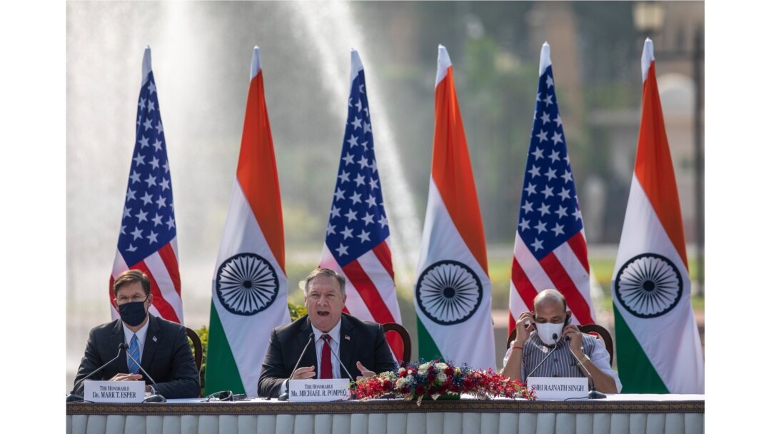 U.S. Secretary of State Mike Pompeo, center, speaks as Secretary of Defence Mark Esper, left, and Indian Defence Minister Rajnath Singh sit beside him during a joint press conference at Hyderabad House in New Delhi, India, Oct. 27, 2020.
