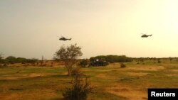 French military helicopters fly above the crash site of Air Algerie flight AH5017 near the northern town of Gossi, Mali, July 24, 2014. 