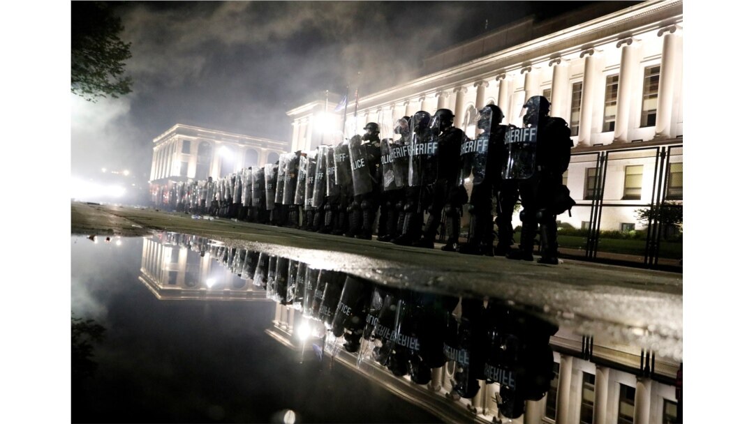 Law enforcement officers guard during a protest following the police shooting of Jacob Blake, a Black man, in Kenosha, Wisconsin, Aug. 25, 2020.