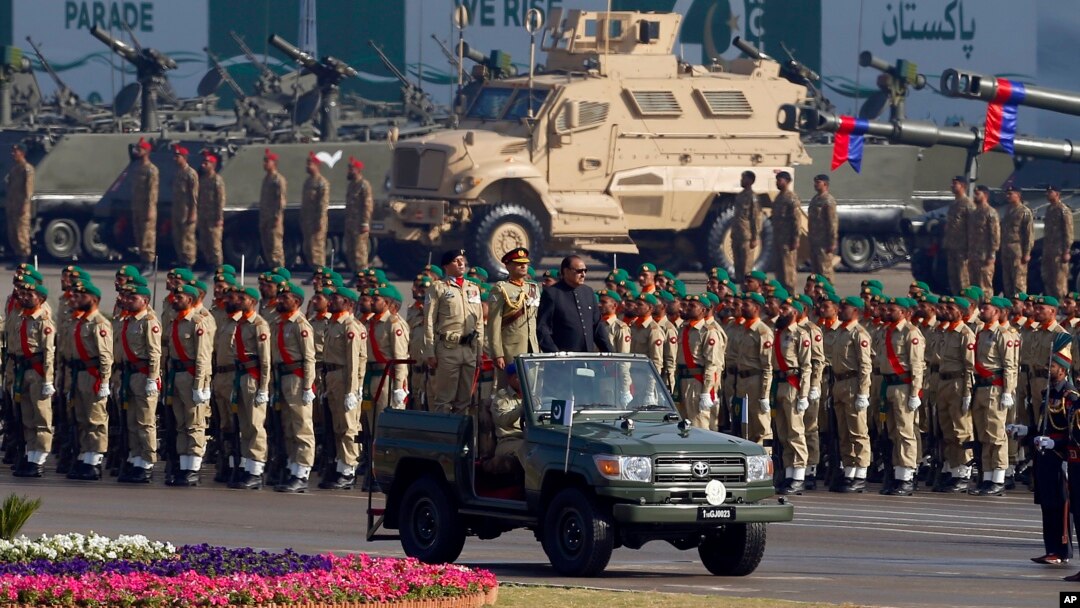 FILE - Pakistan's President Mamnoon Hussain, center on a military vehicle, reviews a military parade to mark Pakistan's Republic Day, in Islamabad, Pakistan, March 23, 2017. 