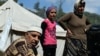 FILE - Syrian Turkmen at a makeshift refugee camp some kilometers away from the Syria-Turkey border, Apr. 23, 2013. 