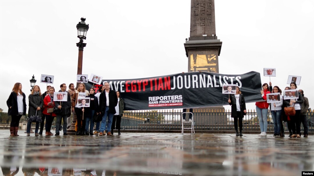 FILE - Reporters Without Borders (RSF) activists demonstrate against restriction on the press in Egypt and to demand the release of detained journalists as part of a two-day visit of Egyptian leader Abdel Fattah al-Sisi in Paris, France, Oct. 24, 2017.