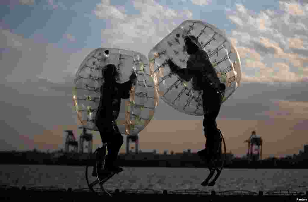 Ryoichi Ando (R), 27, a virtual-reality researcher and an inventor of &quot;Bubble Jumper,&quot; competes with his opponent as they demonstrate the sport in Tokyo, Japan.