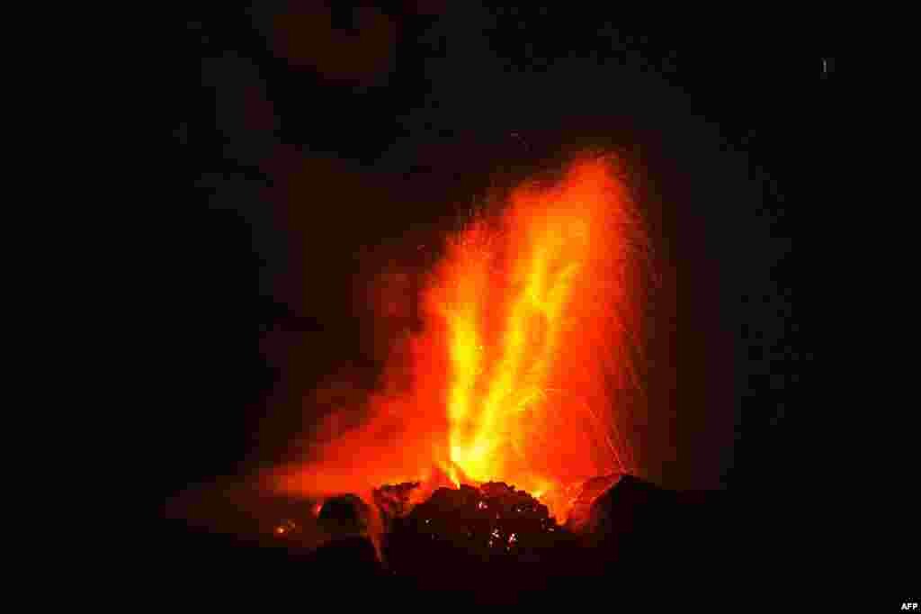Mount Sinabung volcano spews thick volcanic ash as seen from Beganding village in Karo, Indonesia.