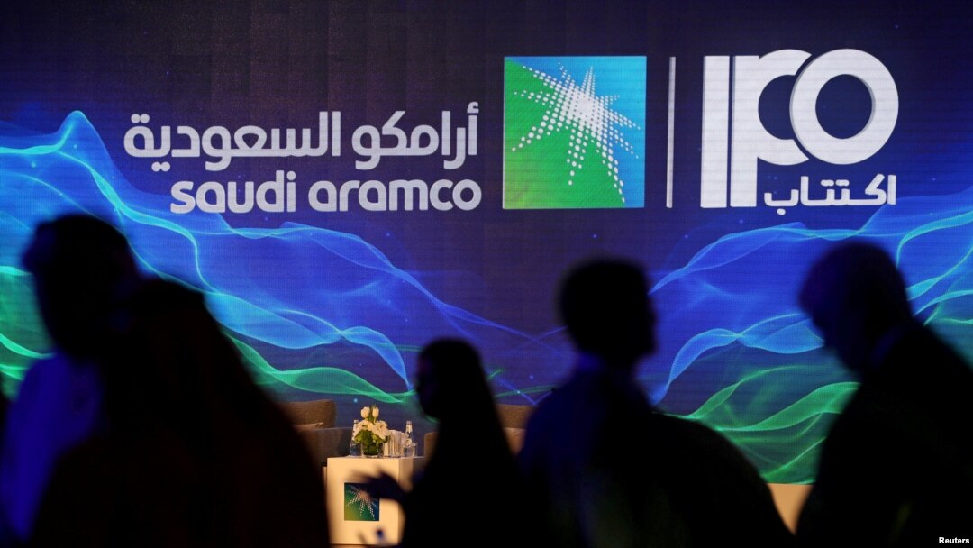 FILE - A sign referring to Saudi Aramco's initial public offering is seen during a news conference by the state oil company at the Plaza Conference Center in Dhahran, Saudi Arabia, Nov. 3, 2019.