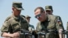 Russian Security Council Deputy Chairman and the head of the United Russia party Dmitry Medvedev, right, listens to an officer as he visits the Pogonovo military training ground in Voronezh region of Russia, July 17, 2024.