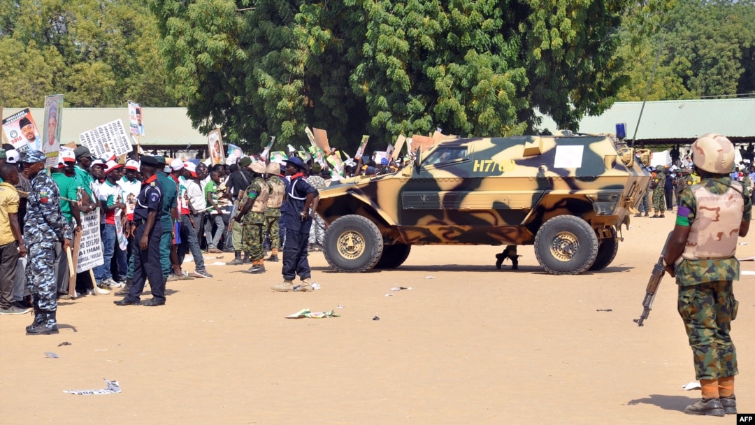 Soldiers and security block a road as they secure the venue during a rally of the ruling People's Democratic Party in Maiduguri, Nigeria, Jan. 24, 2015. 