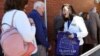 FILE - Liberal Party candidate Gladys Liu (R) speaks with early voters in the May 18 election for the outer Melbourne electorate of Chisholm, in Melbourne, Australia, May 7, 2019.