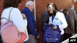 FILE - Liberal Party candidate Gladys Liu (R) speaks with early voters in the May 18 election for the outer Melbourne electorate of Chisholm, in Melbourne, Australia, May 7, 2019.