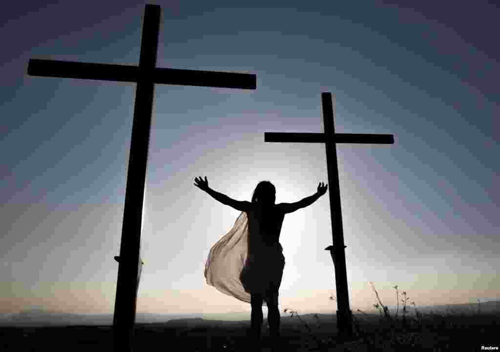 A local resident, playing the role of Jesus Christ, reenacts Jesus Christ's crucifixion during a Via Crucis representation on Good Friday in Cuevas del Campo, Spain.