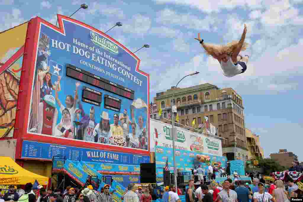 A person jumps on a trampoline before Nathan's Famous Fourth of July International Hot Dog-Eating Contest at Coney Island in Brooklyn, New York.