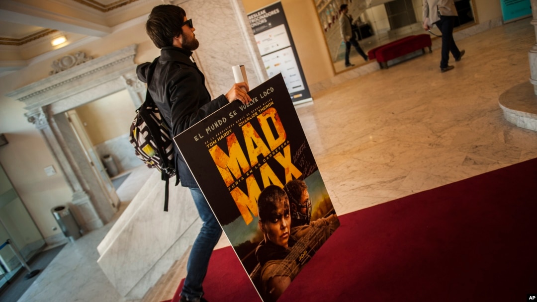 FILE - A spectator arrives at the Maria Victoria cinema to watch ''Mad Max. Fury Road'' during the 63rd San Sebastian Film Festival, in San Sebastian, northern Spain, Sept. 18, 2015.