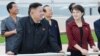 North Korean leader Kim Jong Un (2nd L) and a woman being identified by state TV as his wife 'Comrade Ri Sol Chu,' visit the Rungna People's Pleasure Ground, which is nearing completion, in Pyongyang, July 25, 2012.