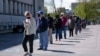 People line up outside a newly reopened career center for in-person appointments in Louisville, Apr. 15, 2021.