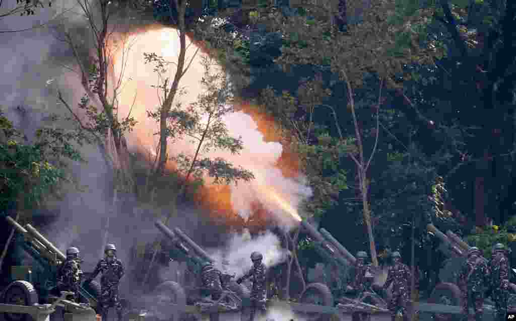 Philippine Army Battery Unit fires a 105-mm Howitzer cannon for a 21-gun salute to honor President Rodrigo Duterte during the 120th anniversary celebration of the Philippine Army, at Fort Bonifacio in suburban Taguig city, east of Manila.
